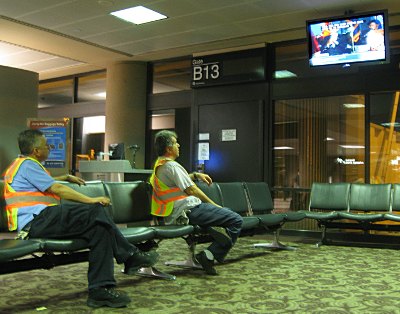 Ground staff at Phoenix airport watch the inauguration coverage